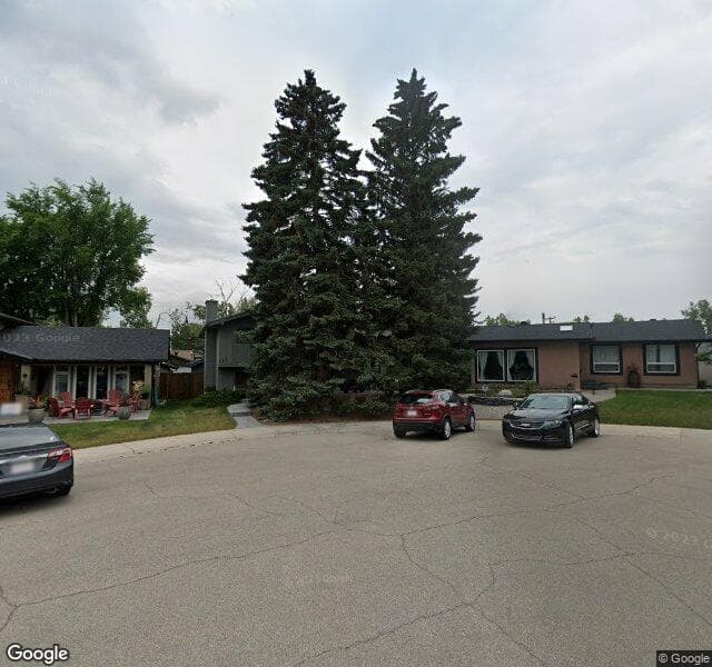 Street view of 120 Lake Acadia Place SE, Calgary
