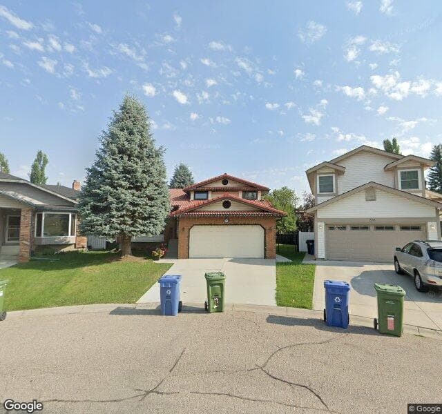 Street view of 232 Woodstock Place SW, Calgary