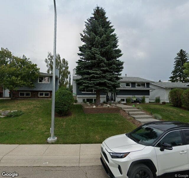 Street view of 144 Lake Acadia Place SE, Calgary