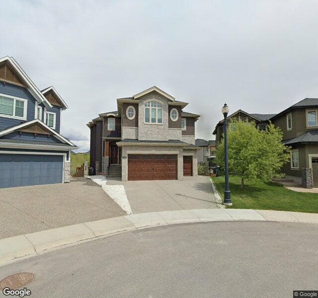 Street view of 210 Rockcliff Bay NW, Calgary