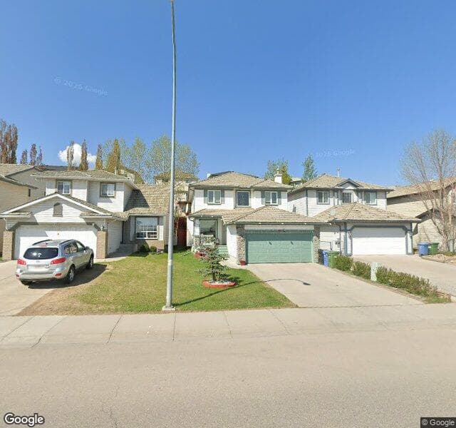 Street view of 332 Harvest Hills Drive NE, Calgary