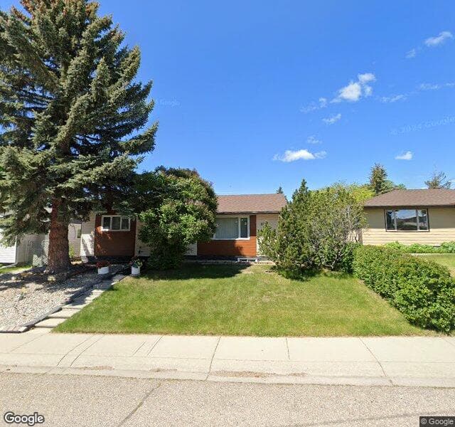 Street view of 8031 Huntwick Hill NE, Calgary